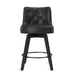 Black upholstered swivel bar stool  with tufed design,back ,round seat and foot rest