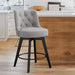 Gray upholstered swivel bar stool in a kitchen  with tufed design,back ,round seat and foot rest