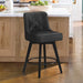 Black upholstered swivel bar stool in a kitchen with tufed design,back and foot rest