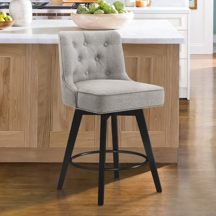 Gray upholstered swivel bar stool in a kitchen with tufed design,back and foot re