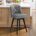 Dark grey upholstered swivel bar stool in a kitchen with tufed design,back and foot rest