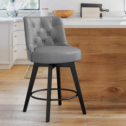 Dark grey upholstered swivel bar stool in a kitchen with tufed design,back ,round seat and foot rest
