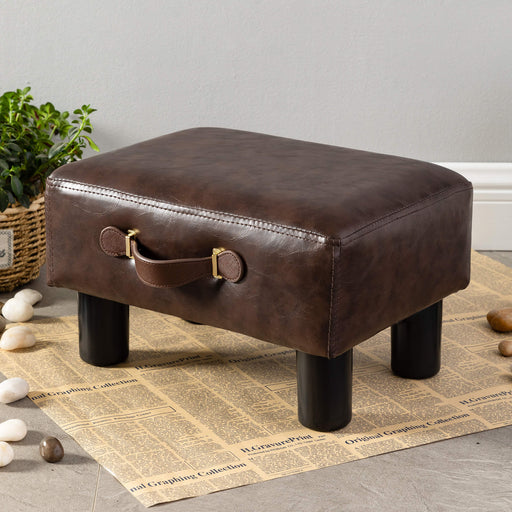 brown leather cushioned footrest with handle